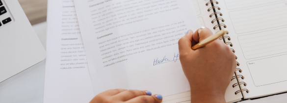 Top down view of someone writing in a notebook