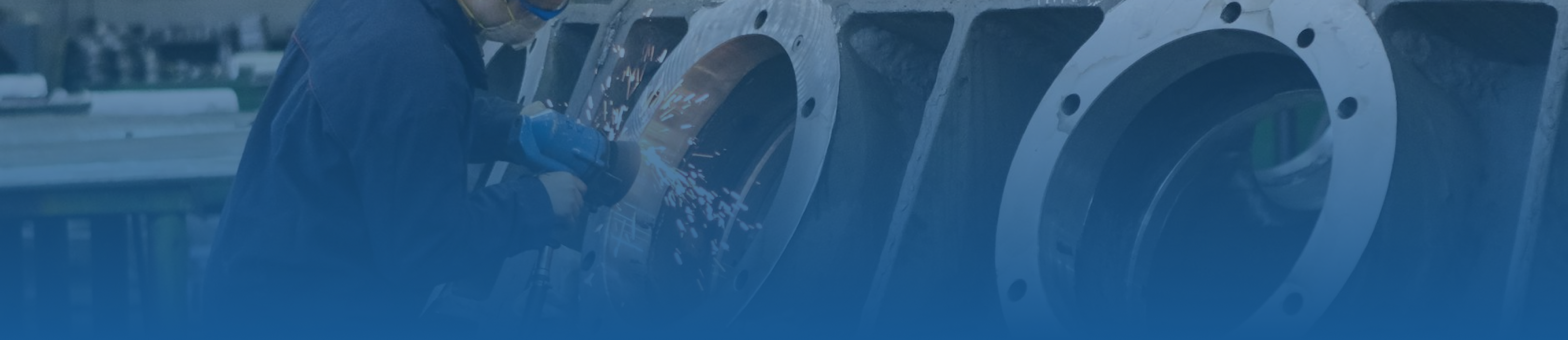 Blue tint frame hero image with a man using a grinder on a metal piece of equipment in an industrial setting