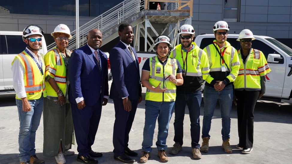 Deputy Under Secretary Eric Morrissette with hard hat workers